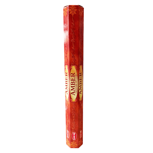 A hexagonal red and gold package of HEM Amber incense sticks on a solid Transparent background. | Ideal Indiska LIVS
